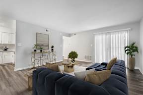A living room with a dark blue sofa and a coffee table.