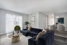 A living room with a dark blue sofa and a coffee table.