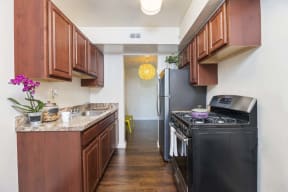 a kitchen with black appliances and wooden cabinets