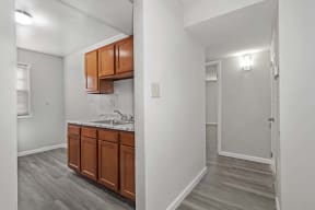 two views of a kitchen and a room with a counter