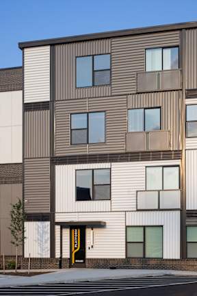 A modern building with a combination of brown and white panels.