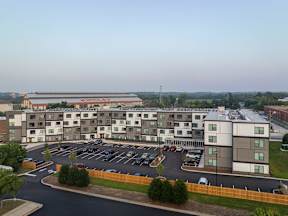 A large building with a parking lot in front of it.