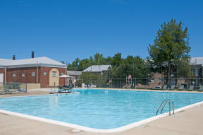 a swimming pool with a building in the background