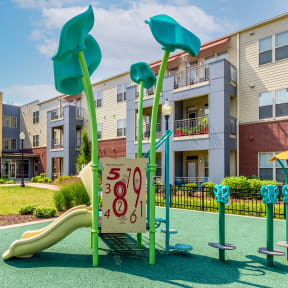 a playground in front of an apartment building