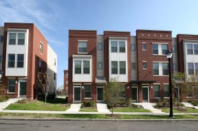 a row of brick apartment buildings on a city street