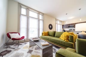 a living room with a green couch and a coffee table