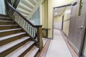 a hallway with stairs and a door to a elevator