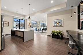 A modern office space with a reception desk and a long table.
