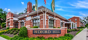Bedford Hill Apartments leasing office a brick building with a sign