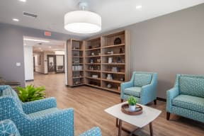a waiting room with blue chairs and a table