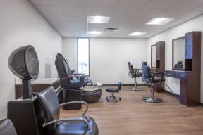 a salon room with a variety of chairs and a tv