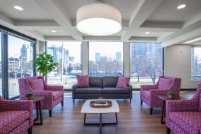 a lounge area with chairs and couches and a coffee table