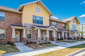 A row of houses with a clear blue sky above them.
