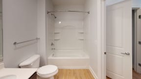 a bathroom with a tub and a toilet and a sink at City Square 162
