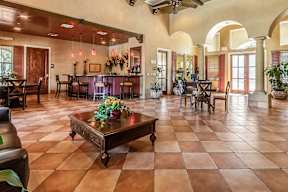 A large room with a table and chairs in it.