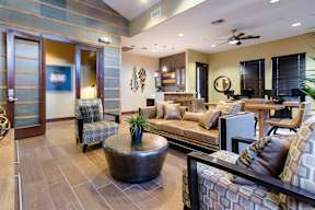 A living room with a brown coffee table and a brown couch.