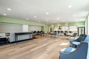 A room with a long table and chairs.