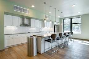A modern kitchen with white cabinets and a large island.