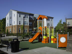 a playground at an apartment complex with a swing set