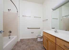 a bathroom with a toilet sink and shower and a tub