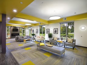 a large lobby with couches and chairs and a fireplace