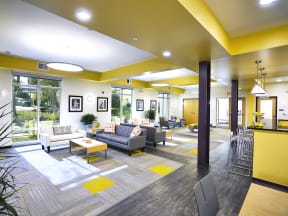 a lobby with couches and chairs and a large window