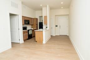 A kitchen with wooden floors and white walls.