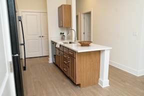 A kitchen with wooden cabinets and a white countertop.