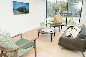 A living room with a couch, chair, and coffee table.