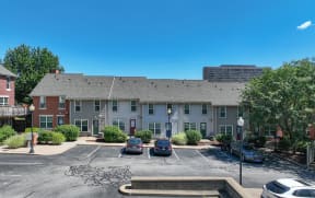 a large apartment building with cars parked in a parking lot at Crawford Square Apartments & Townhomes