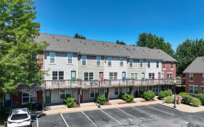 an exterior view of an apartment building with a parking lot at Crawford Square Apartments & Townhomes