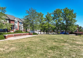 Community greenway with seating and trees at Crawford Square Apartments & Townhomes
