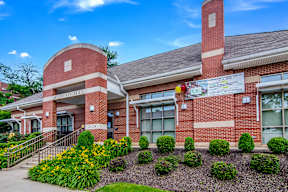 The front of a brick building with a sign that reads "Bridgton Hill".