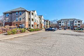 A parking lot in front of apartment buildings.