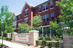 a large brick building with a sign in front of it at McCormack House at Forest Park Southeast Senior apartments in St.  Louis, MO