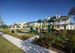 a playground in a park in front of a building