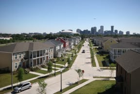 an aerial view of a neighborhood with a city in the background