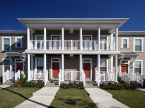 an apartment building with a porch and a walkway