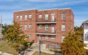 a red brick building with stairs in front of it