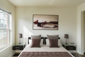 a bedroom with a bed and a painting on the wall at Horace Mann apartments and townhomes in Gary, IN