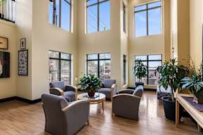 A living room with grey chairs and a coffee table.