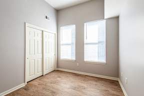 A room with a white door and two windows.
