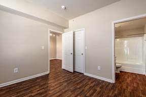 A room with a white door and a white closet.