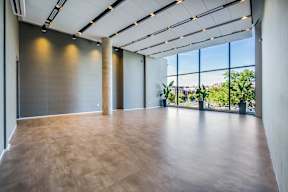 A large room with wooden floors and a long window.