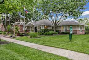 A house with a flag on the front lawn.