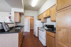 a kitchen with white appliances and wooden cabinets