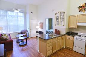 A kitchen with wooden cabinets and a white stove.