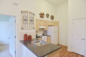 A kitchen with a sink and a refrigerator.
