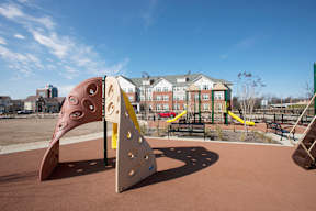 A playground with a slide and a play structure.