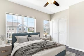 a bedroom with a bed and a ceiling fan at Preservation Square Apartments